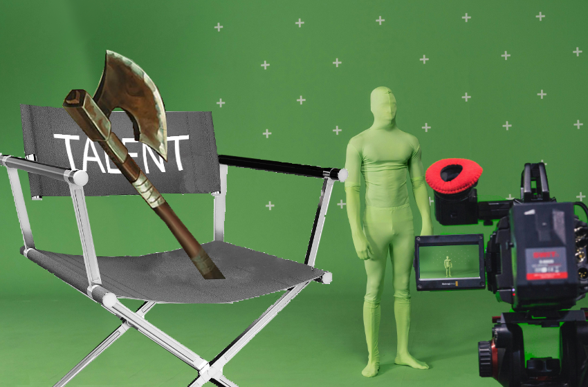 An axe sits on a chair as if giving an interview. Next to the axe is a digital camera filming a man in a green morph suit on a green screen stage.